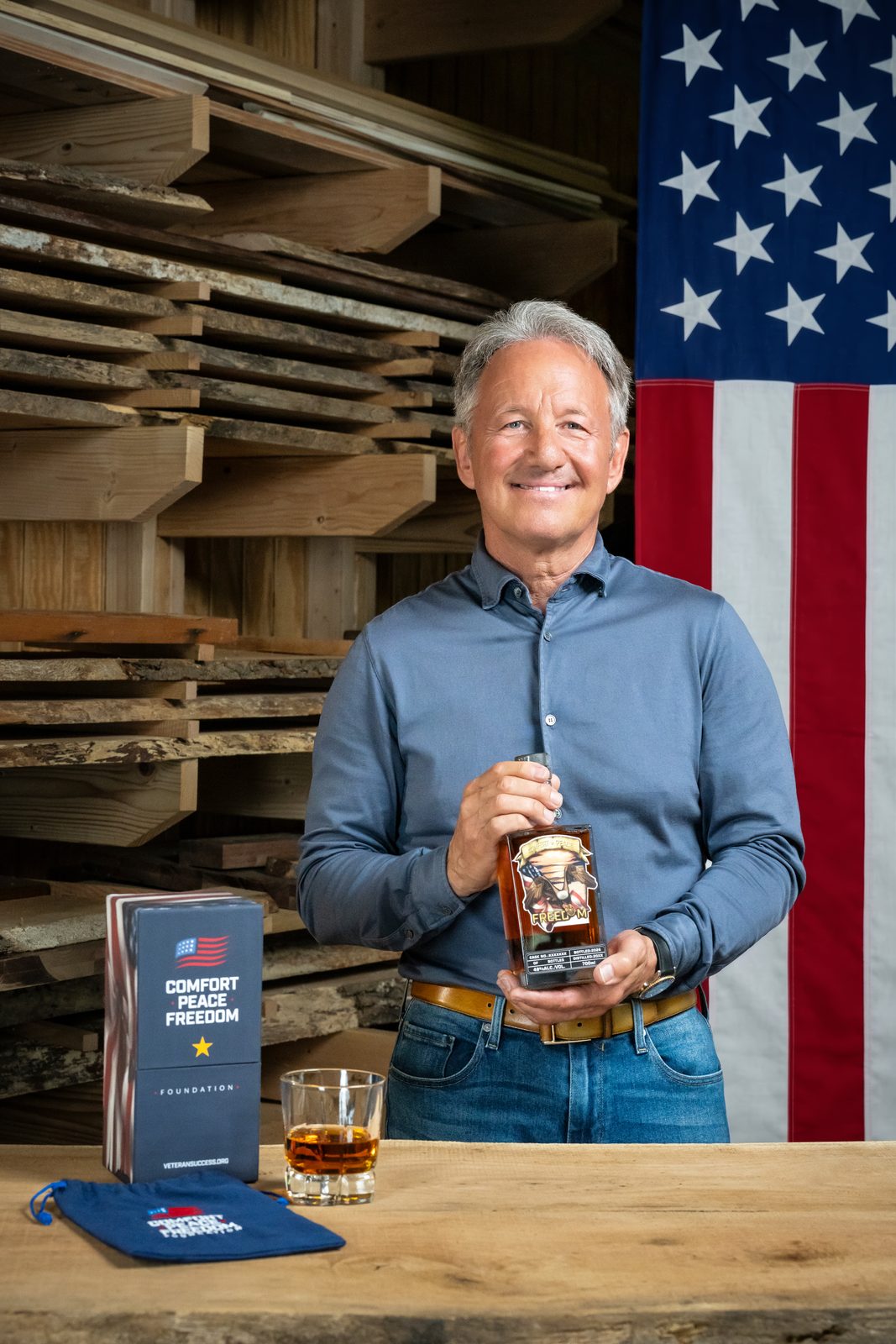 Ken Rusk holding a bottle of Freedom Bourbon